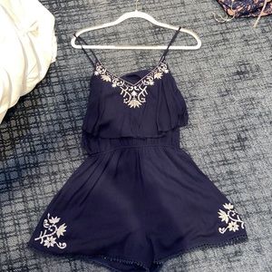 Navy Romper with white embroidered design